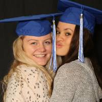 two soon to be graduates hugging for a picture